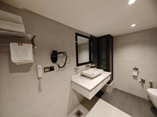a bathroom with a sink and a toilet at Zamzam Hotel 1 in An Najaf