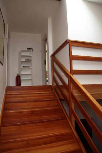 a staircase with wooden railings in a room at Apartmán Skalka in Mnichovo Hradiště