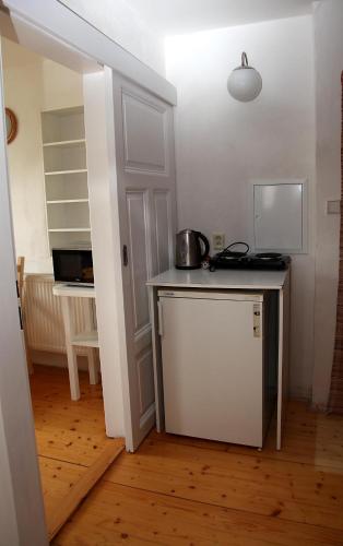 a small kitchen with a counter and a microwave at Apartmán Skalka in Mnichovo Hradiště
