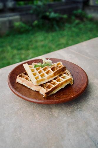 two waffles on a plate on a table at Abian Bali Resort Amed in Amed
