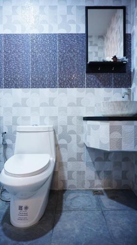 a bathroom with a white toilet and a sink at TinyHouse at TigerCave in Ko Bu Bu