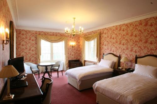 Ένα ή περισσότερα κρεβάτια σε δωμάτιο στο Donnington Grove Hotel & Golf Club