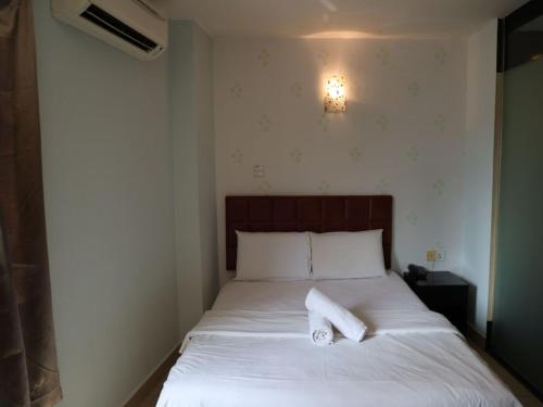 a bedroom with a bed with two towels on it at Hotel O D Nice Inn Hotel in Kuala Lumpur