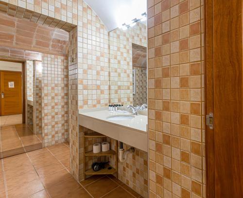 a bathroom with a sink and a mirror at Hotel Llar de Capitans in Masnou