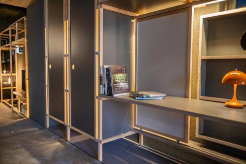a room with a desk with a lamp and books at Mi-Kan Design Hotel in Tokyo