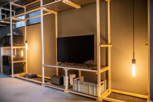 a room with a flat screen tv on a shelf at Mi-Kan Design Hotel in Tokyo