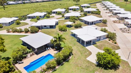 an aerial view of a resort with a pool and buildings at Casa Nostra Motel in Rockhampton