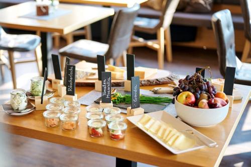 a table with a bowl of fruit and a bowl of cheese at Wolfegg in Warth am Arlberg