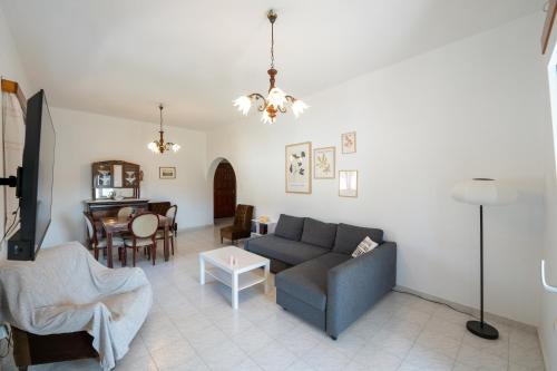 a living room with a couch and a table at Maria's Home Aegina in Kondós