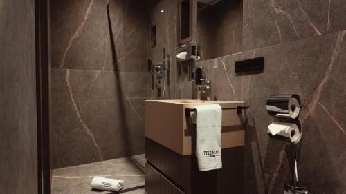 a bathroom with a sink and toilet paper at Bellman Hotel in Berlin