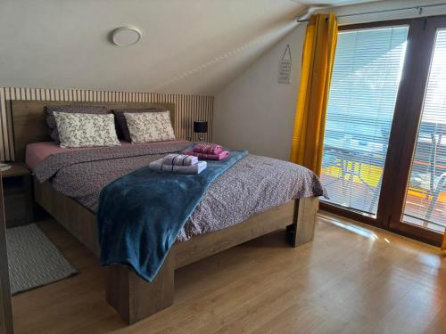 a bedroom with a bed with two towels on it at Holiday Home Bella Vita in Gornji Mihaljevec