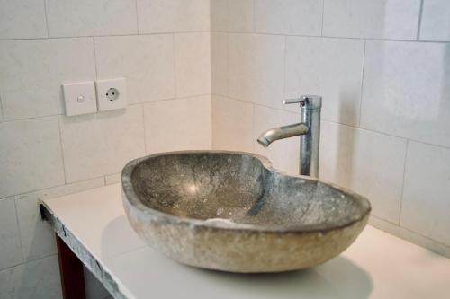 a bathroom sink with a faucet on a counter at Abian Bali Resort Amed in Amed