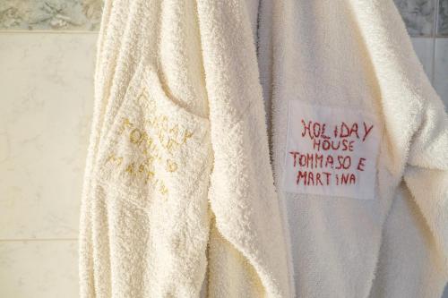 a white sweater with a sticker on it on a wall at Holiday Home Tommaso e Martina in Savoca 