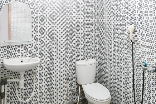 a bathroom with a toilet and a sink at RedDoorz at Amanah Syariah Residence Tanjung Karang Lampung in Tanjungkarang