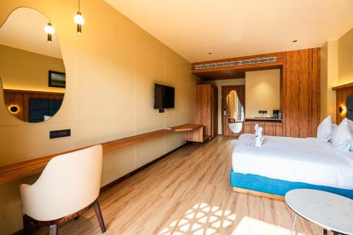 a hotel room with a bed and a table at The White Rock Inn & Dine in Shillong