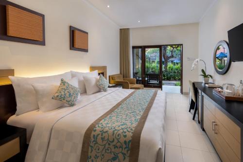 a bedroom with a large bed in a room at Adhi Jaya Hotel in Kuta