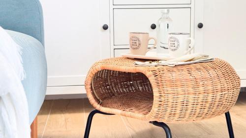 a wicker chair with two cups on top of it at Ca' Egle by Ca-Sa Check in Chioggia