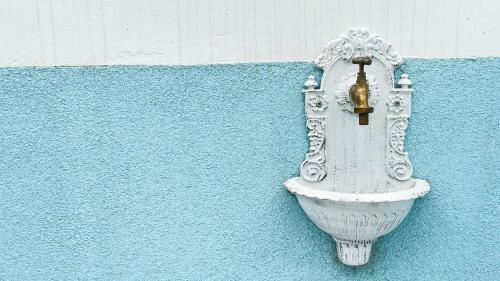 a white toilet on a blue wall at Ca' Egle by Ca-Sa Check in Chioggia
