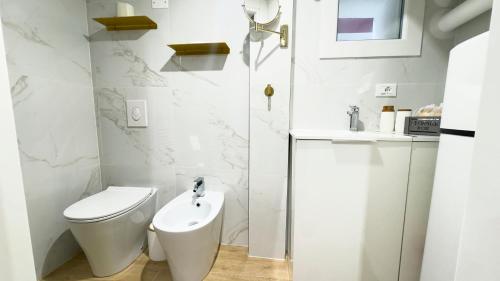 a white bathroom with a toilet and a sink at Ca' Egle by Ca-Sa Check in Chioggia