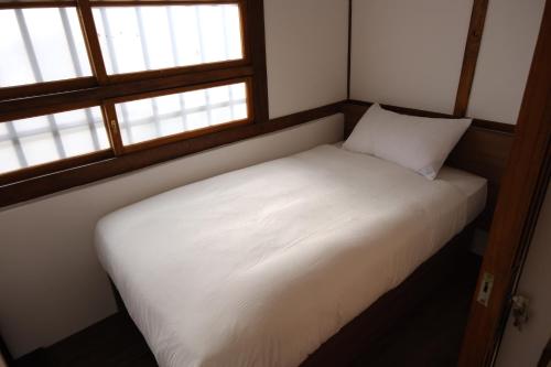 Ein Bett oder Betten in einem Zimmer der Unterkunft Machiya Posong