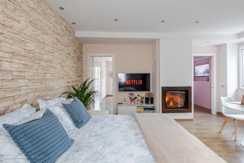a bedroom with a large bed and a fireplace at Laura Blu Charme Casa rilassante Lago di Bolsena in Valentano