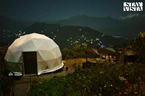a white tent with a view of a mountain at StayVista at The Stargazer with Mountain Views, Bonfire, Lawn in Pelling