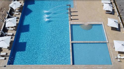 an overhead view of a large swimming pool with umbrellas at WAAFI CITY CENTER RESIDENCE in Djibouti