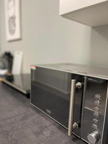 a microwave oven sitting on top of a kitchen counter at Unique loft for 8 in Eggenstein-Leopoldshafen