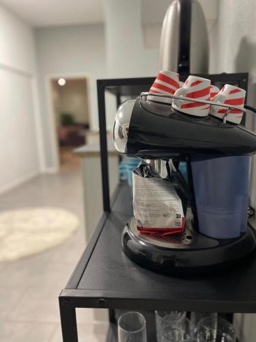 a mixer sitting on a table with a cup at Unique loft for 8 in Eggenstein-Leopoldshafen