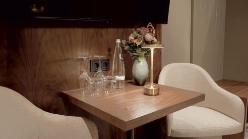 a wooden table with a vase of flowers on it at Bellman Hotel in Berlin