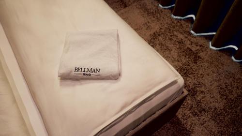 a white bed with a napkin on top of it at Bellman Hotel in Berlin