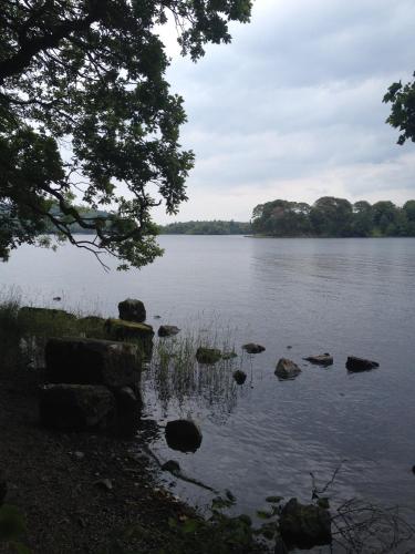 a view of a lake with rocks in the water at Yeats Lodge in Drumcliff