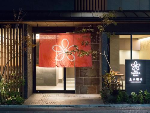 a store front with a sign on the door at Stay SAKURA Kyoto Higashi Hongan-ji I in Kyoto