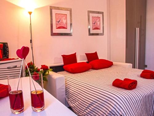 a room with a bed with red pillows on it at The Relax Apartment in Montagnana