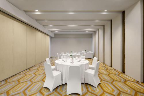 a conference room with a white table and white chairs at Hotel Santika BSD City-Serpong in Serpong