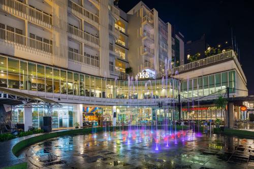 a fountain in front of a building at night at Hotel Santika BSD City-Serpong in Serpong
