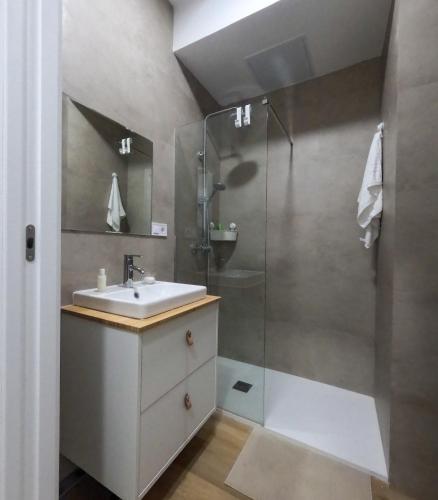 a bathroom with a sink and a shower at Anna Home in Telde