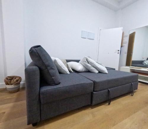 a blue couch with pillows on it in a living room at Anna Home in Telde