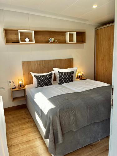a bedroom with a large bed with two night stands at Hof Schmörholm Dein Familienurlaub auf dem Bauernhof in Leck
