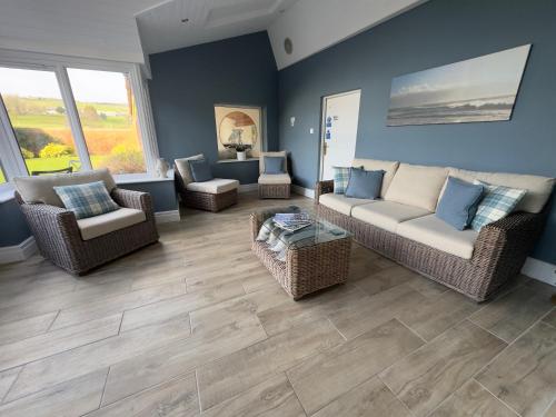 a living room with a couch and chairs at Vast, Elegant Home with Indoor Pool & Sauna near Popular Golf Course in Kington