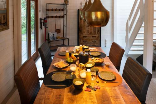 a wooden table with food on top of it at ZenCabin - Luxe en Wellness in de natuur in Hulshout