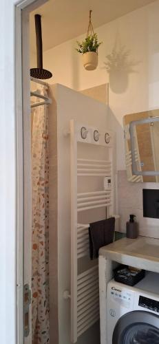 a kitchen with a washer and dryer in a room at Suite Moulin de la Calade -Tower View, Heart of Provence & AC in Le Luc