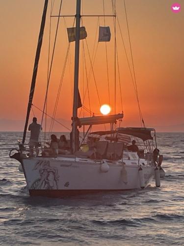 a group of people on a sail boat in the ocean at AGROLOGY LUX - 4 BEDROOM Luxurious villa on an Agricultural Haven Retreat in Sálakos