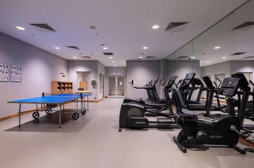 a gym with a ping pong table and exercise equipment at Park Inn by Radisson Samsun in Samsun