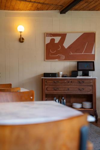 a kitchen with a table and a tv on the wall at Kazbegi cabins in Stepantsminda