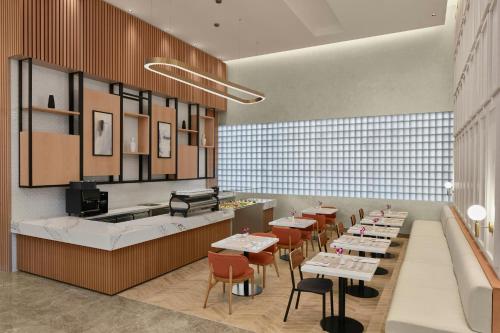 a restaurant with tables and chairs and a counter at Courtyard by Marriott Makkah in Makkah