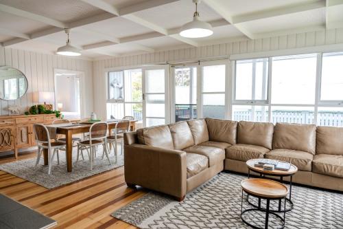 a living room with a couch and a table at Metung Holiday House in Metung