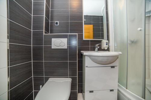 a small bathroom with a toilet and a sink at Villa Tucepi Beach in Tučepi