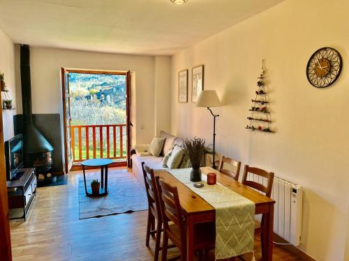 a living room with a dining room table and a living room with a tableablish at Mirador de la Neu in Pla de l'Ermita