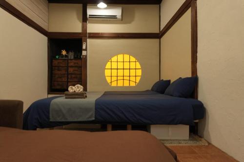 a bedroom with two beds and a window at SYMPOSION Locanda in Kamakura